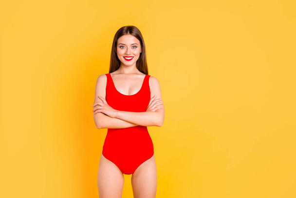 Happy brunett girl with big smile looking at camera crossed her arms over her chest isolated on vivid yellow background with copy space - Zdjęcie, obraz