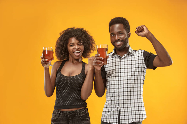 The afro couple or happy young people laughing and drinking beer at studio - 写真・画像