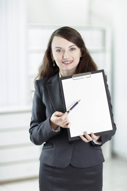 modern business woman pointing at blank sheet. - Foto, immagini