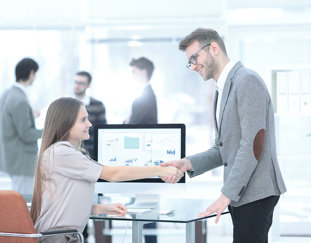 Manager and employee shaking hands to each other as a sign of success - Photo, image