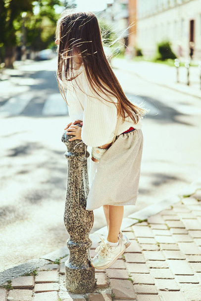 Fashion portrait of young girl wearing long dress, tights and modern sneakers shoes - Foto, afbeelding