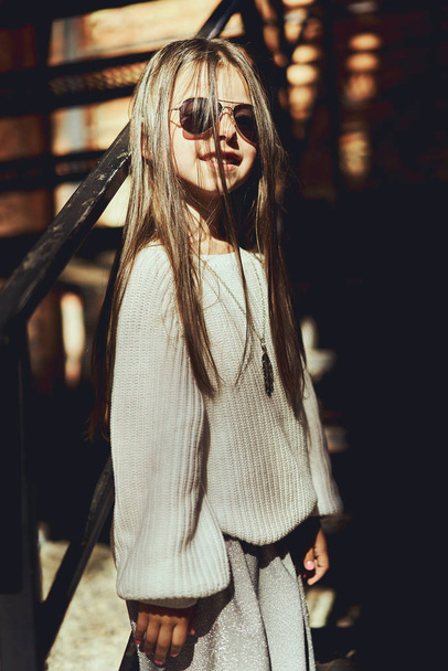 Little girl model, posing fashionable clothes, walking around the city - Φωτογραφία, εικόνα