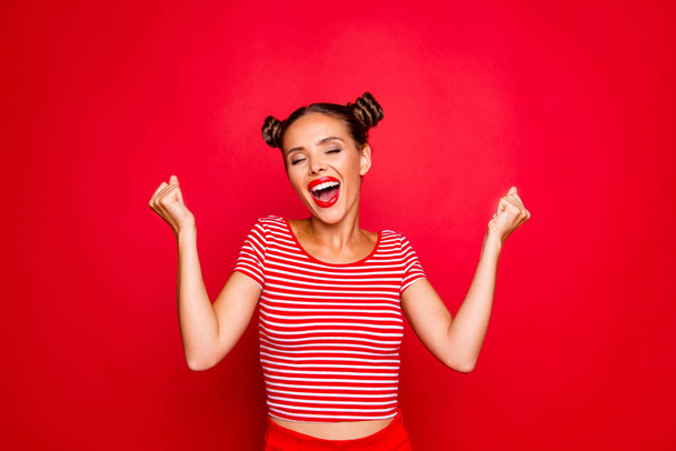 Portrait of cheerful girl with toothy smile raised hands and showing successful celebrate goal isolated on red background - Фото, изображение