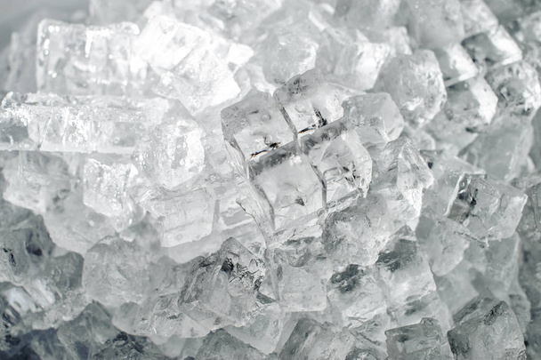 Textured background of a small clear ice cubes in the heap on the ice production plant - Zdjęcie, obraz