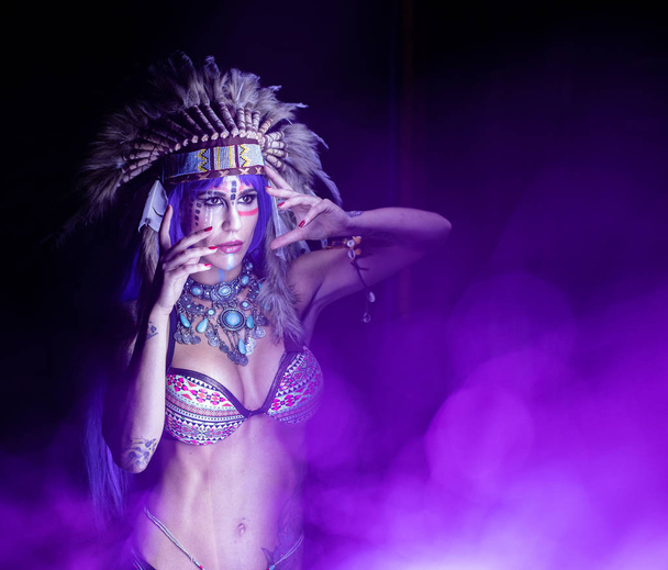 Woman dressed as an Indian poses as a model amidst long exposure lights - Fotó, kép