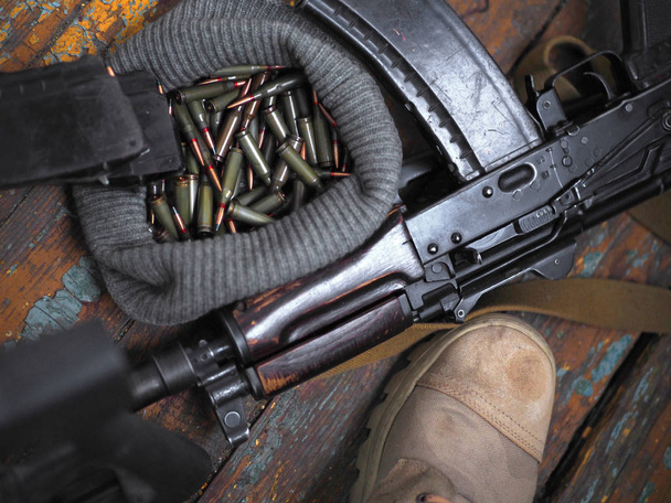 soldier feet and AK rifle on the floor close up - Photo, Image
