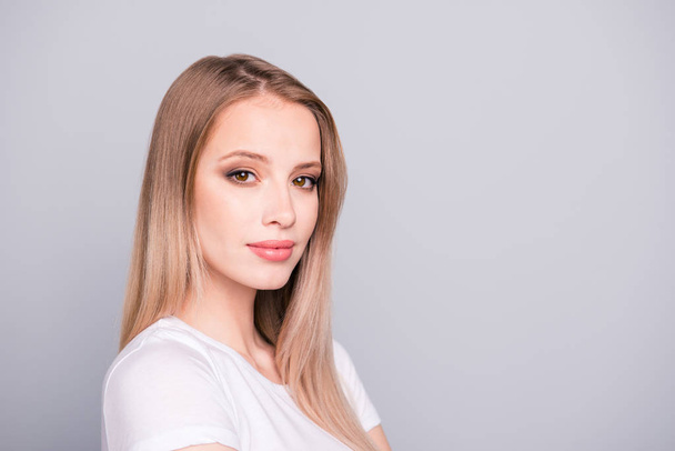Portrait of young caucasian, charming, attractive gorgeous smiling girl wearing casual white t-shirt. Isolated over grey background, copy space - Valokuva, kuva