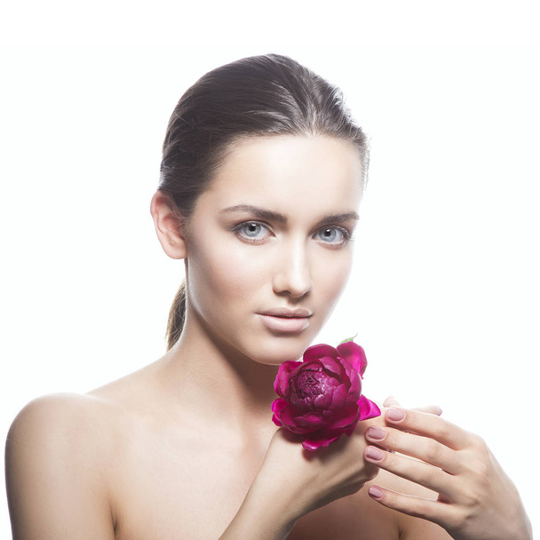 Portrait of young woman with natural makeup and peony flower on white background - Φωτογραφία, εικόνα