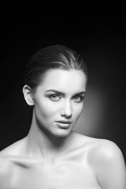 Portrait of young woman with natural makeup on black background - Photo, image