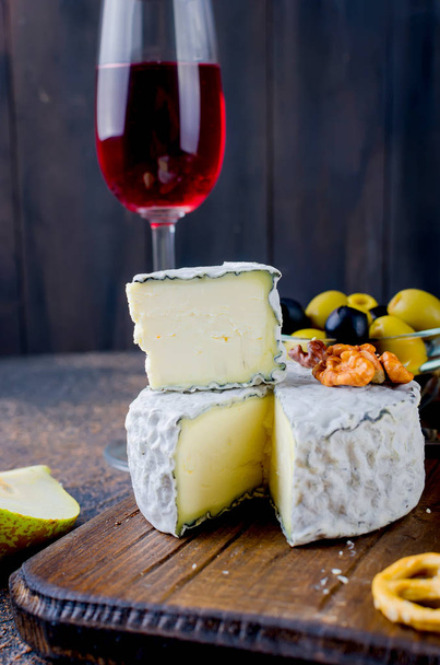 cheese sliced, cheese with mildew, hard cheese, olives, walnuts, peanuts, honey, a glass of wine, a romantic dinner, a meal for the shurman - Photo, Image