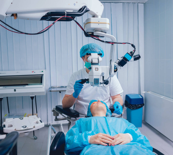 patient and surgeon in operating room during ophthalmic surgery - Foto, imagen