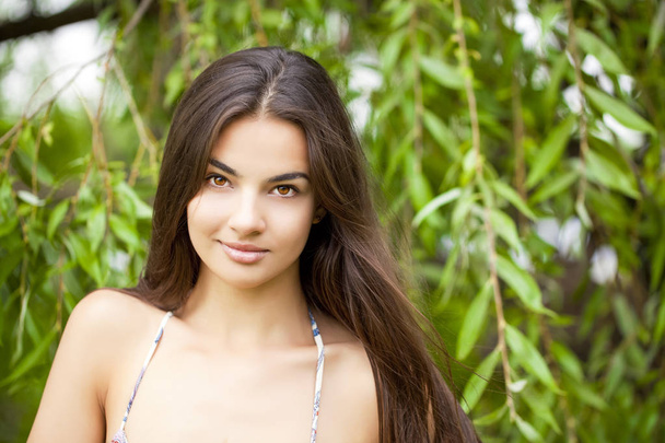 Portrait close up of young beautiful woman, on green background summer nature - Φωτογραφία, εικόνα