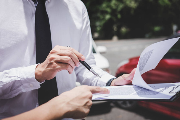 Traffic Accident and insurance concept, Insurance agent working on report form with car accident claim process. - Φωτογραφία, εικόνα
