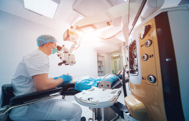 patient and surgeon in operating room during ophthalmic surgery - Photo, image