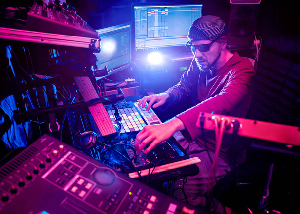 Sound engineer working at mixing panel in the in sound recording studio. Modern background - Φωτογραφία, εικόνα