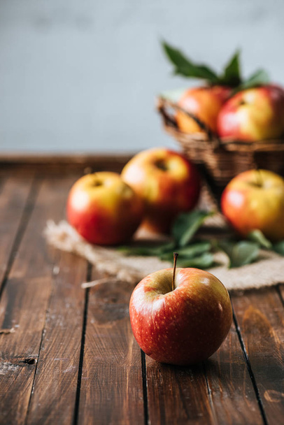 selective focus of fresh apples on dark wooden surface - Foto, Imagem