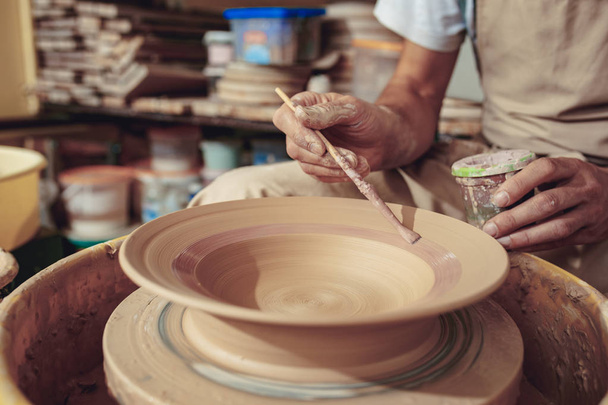 Creating a jar or vase of white clay close-up. Master crock. Man hands making clay jug macro. - Zdjęcie, obraz