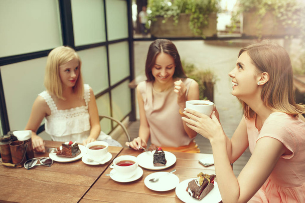 Two girl friends spend time together drinking coffee in the cafe, having breakfast and dessert. - Photo, image