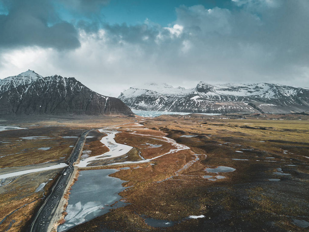 Vatnajokull glacier aerial drone image with street highway and clouds and blue sky. Dramatic winter scene of Vatnajokull National Park, Iceland, Europe. Beauty of nature concept background. - Photo, image