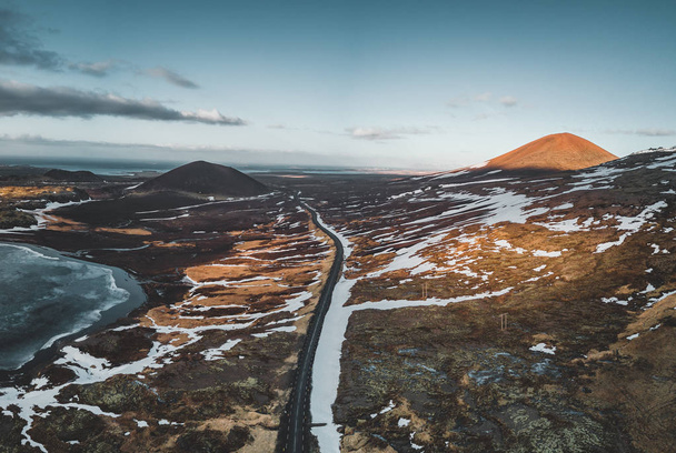 Aerial drone photo of a empty lake and street highway 1 with a huge volcanic mountain Snaefellsjokull in the distance, Reykjavik, Iceland. - Photo, image