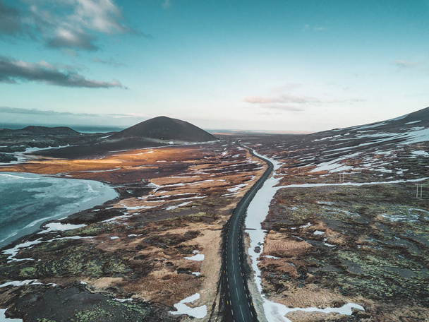 Aerial drone photo of a empty lake and street highway 1 with a huge volcanic mountain Snaefellsjokull in the distance, Reykjavik, Iceland. - Foto, Bild
