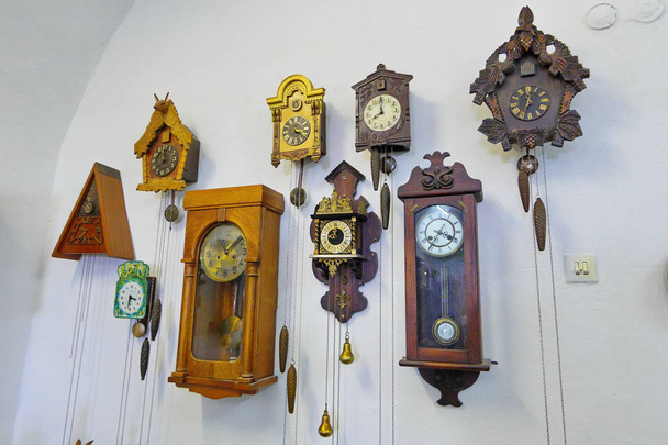 a room with exhibits of ancient clocks of different eras in Palanok castle. Mukachevo.Ukraine - 写真・画像
