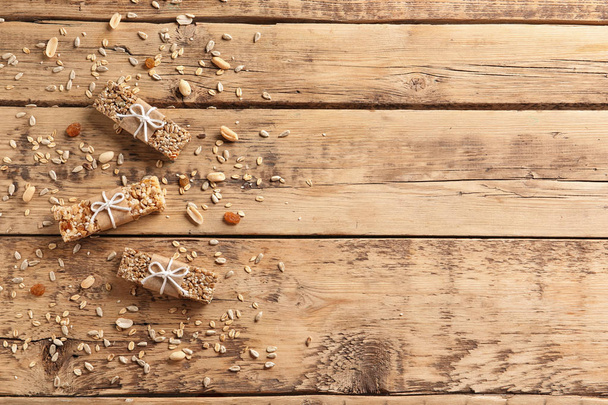 Different homemade grain cereal bars on wooden table, top view - Fotoğraf, Görsel