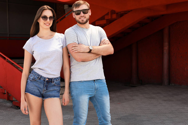 Young couple wearing gray t-shirts on street - Fotoğraf, Görsel