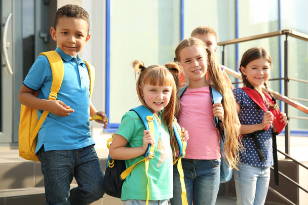 Cute little children with backpacks outdoors. Elementary school - Zdjęcie, obraz