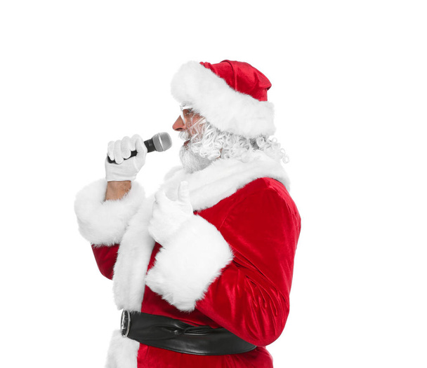Santa Claus singing into microphone on white background. Christmas music - Fotografie, Obrázek