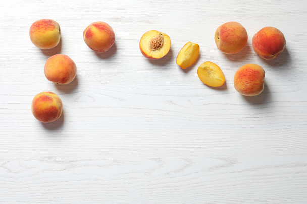 Fresh sweet peaches on wooden table, top view - Photo, Image