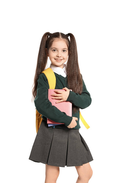Little girl in stylish school uniform on white background - Fotó, kép
