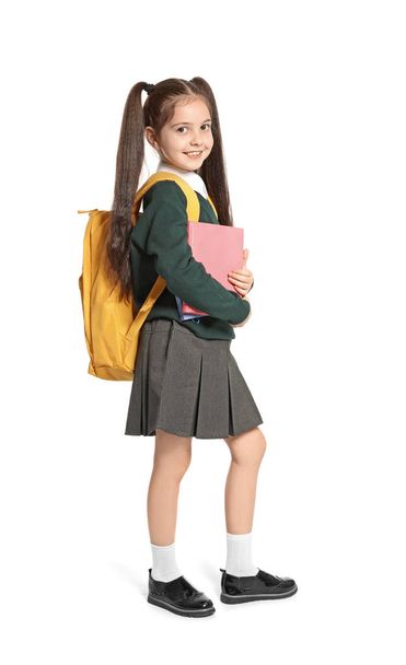 Little girl in stylish school uniform on white background - Фото, изображение