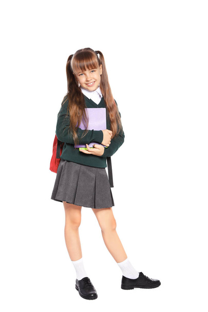 Little girl in stylish school uniform on white background - Zdjęcie, obraz