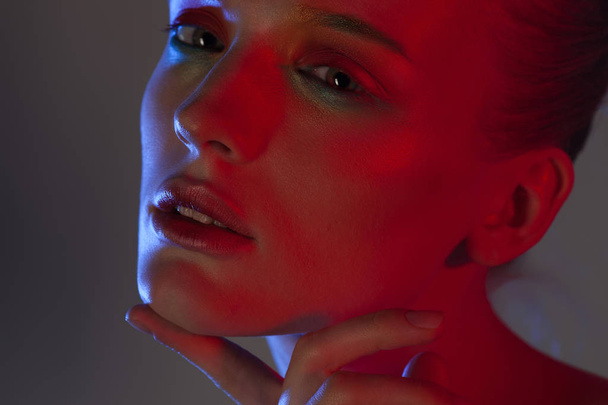 Young beautiful girl with neon lighting. Beauty close-up portrait - Foto, Imagen