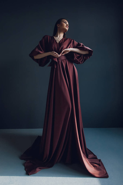 Young elegant girl in burgundy dress. Beauty portrait - Foto, Bild