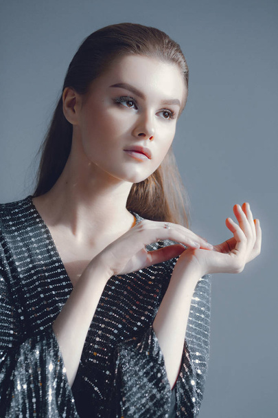 Young elegant girl in black shiny suit in sequins. Beauty portrait - Foto, Bild