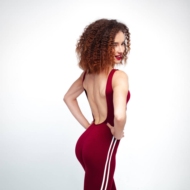 Flirtatious sports girl in burgundy overall. Fitness and Lifestyle - Foto, Imagen