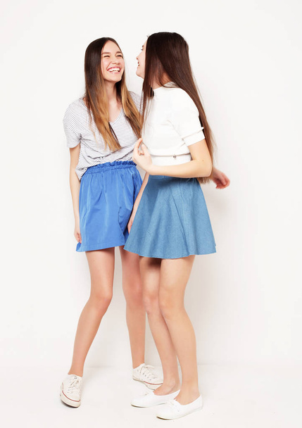 Full body portrait of two happy  girls over white background - Photo, Image