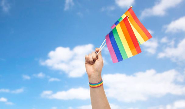 hand with gay pride rainbow flags and wristband - Zdjęcie, obraz