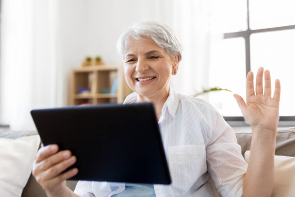 senior woman having video chat on tablet pc - Фото, изображение
