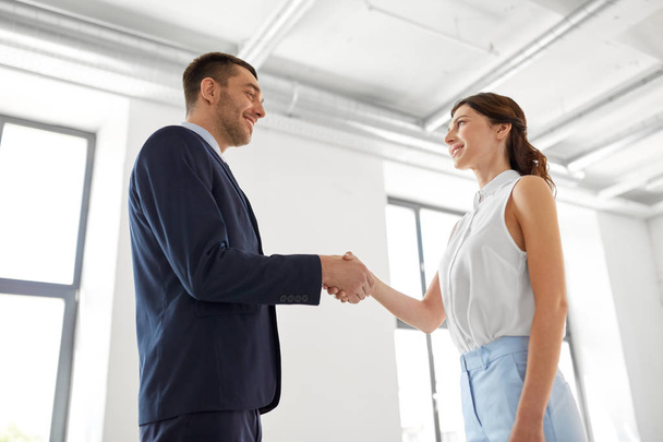 businesswoman and businessman shaking hands - Photo, image
