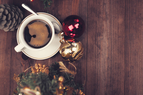 Christmas workplace, cup of coffee and  Christmas tree on a brown wooden textured table. Top view Christmas background - Photo, Image