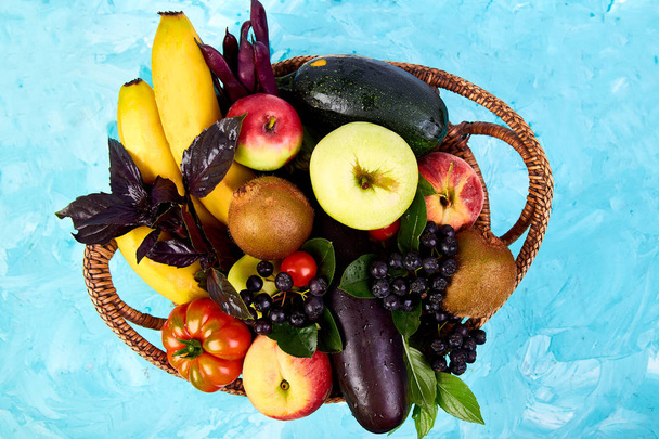Healthy colorful food selection: fruit, vegetable, superfood,  leaf on basket on blue background. Clean eating. Vegan. Detox. Supermarket product. Assortment Fresh Organic. Natural Concept  - Photo, Image