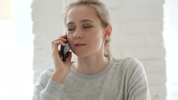 Young Woman Talking on Phone in Loft Workplace - Кадри, відео