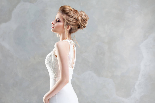 Wedding style. Beautiful young bride with luxury wedding hairstyle - Photo, image