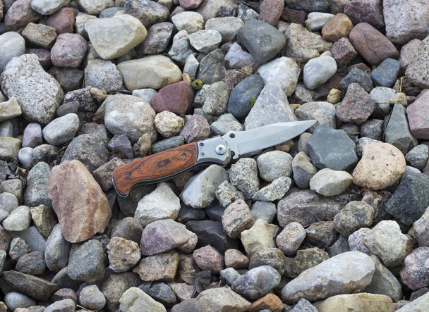 knife in the background of small stones - Zdjęcie, obraz