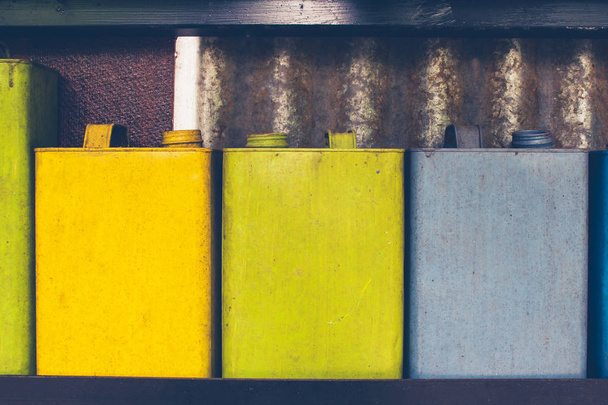 Exterior design and decoration concept : Rows of colorful used kerosene container or oil can decorate on wall. (Selective focus) - 写真・画像