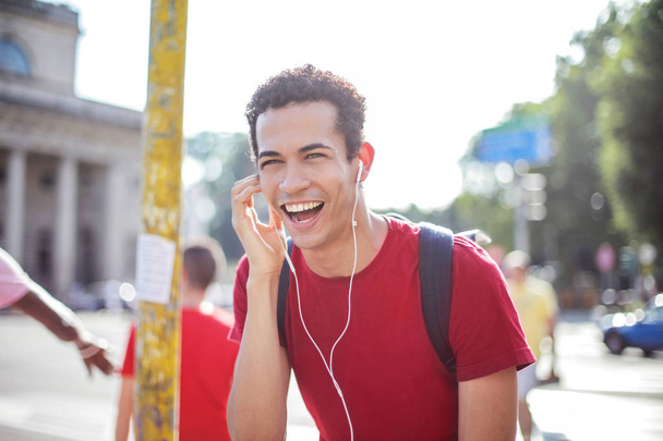 Afro man with earphones laughing. - Fotografie, Obrázek