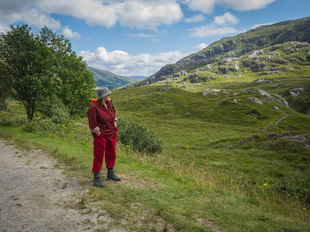 Scotland travel, senior sporty vital woman walking in scottish landscape - Photo, Image